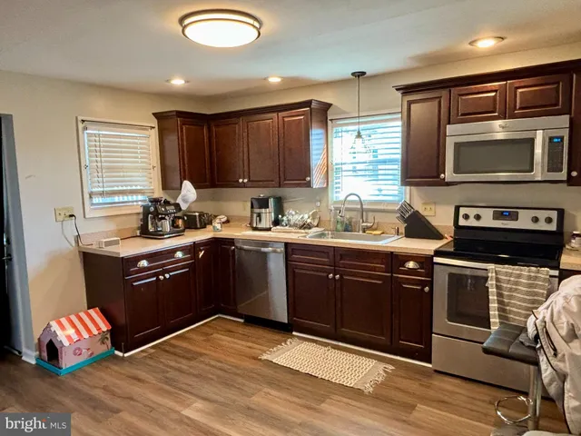 a kitchen with a sink stove and cabinets