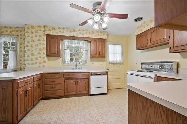 a kitchen with stainless steel appliances granite countertop a sink and cabinets