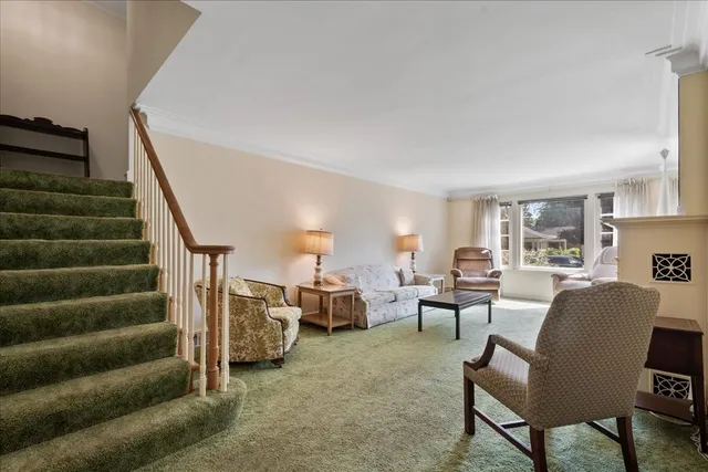 a living room with furniture and stairs