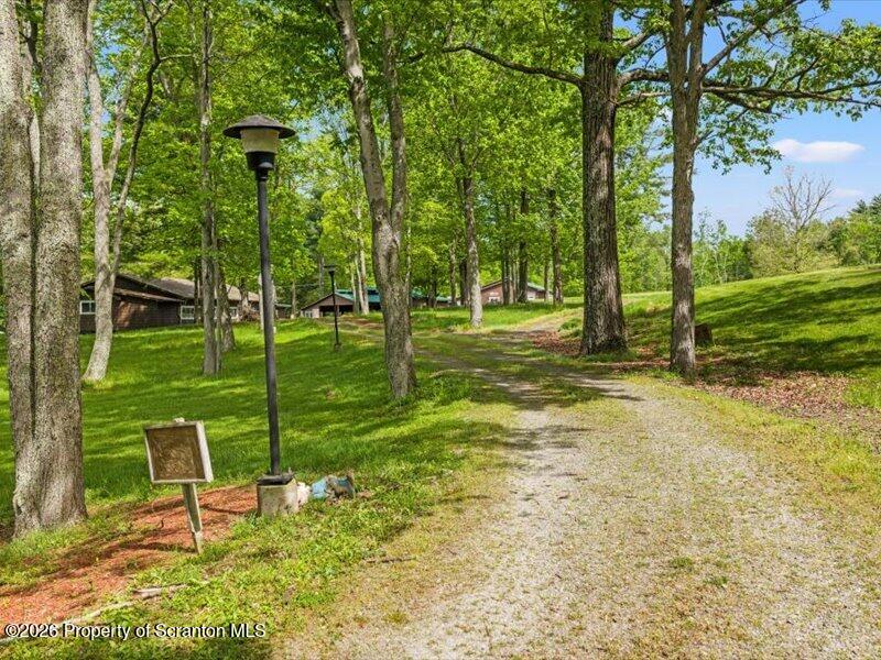 9-17 Vago Road Tunkhannock, PA 18657 - Photo 49 of 57 a view of a park with swings and a table