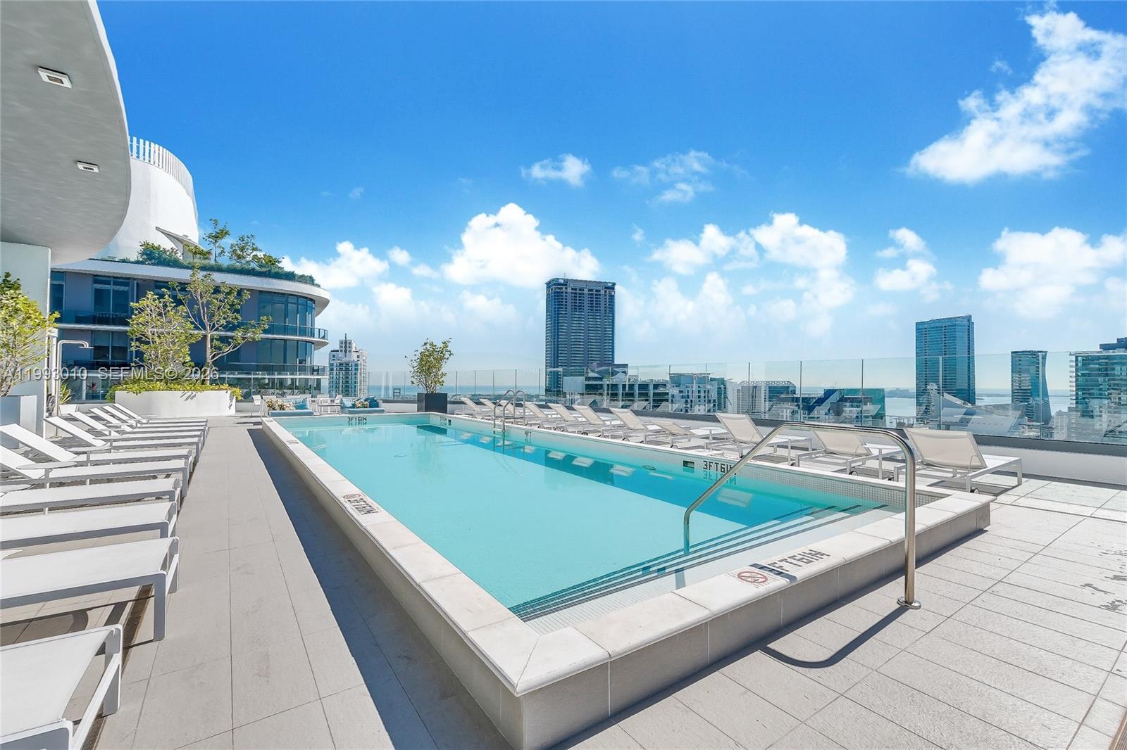 a view of a swimming pool with a lounge chairs