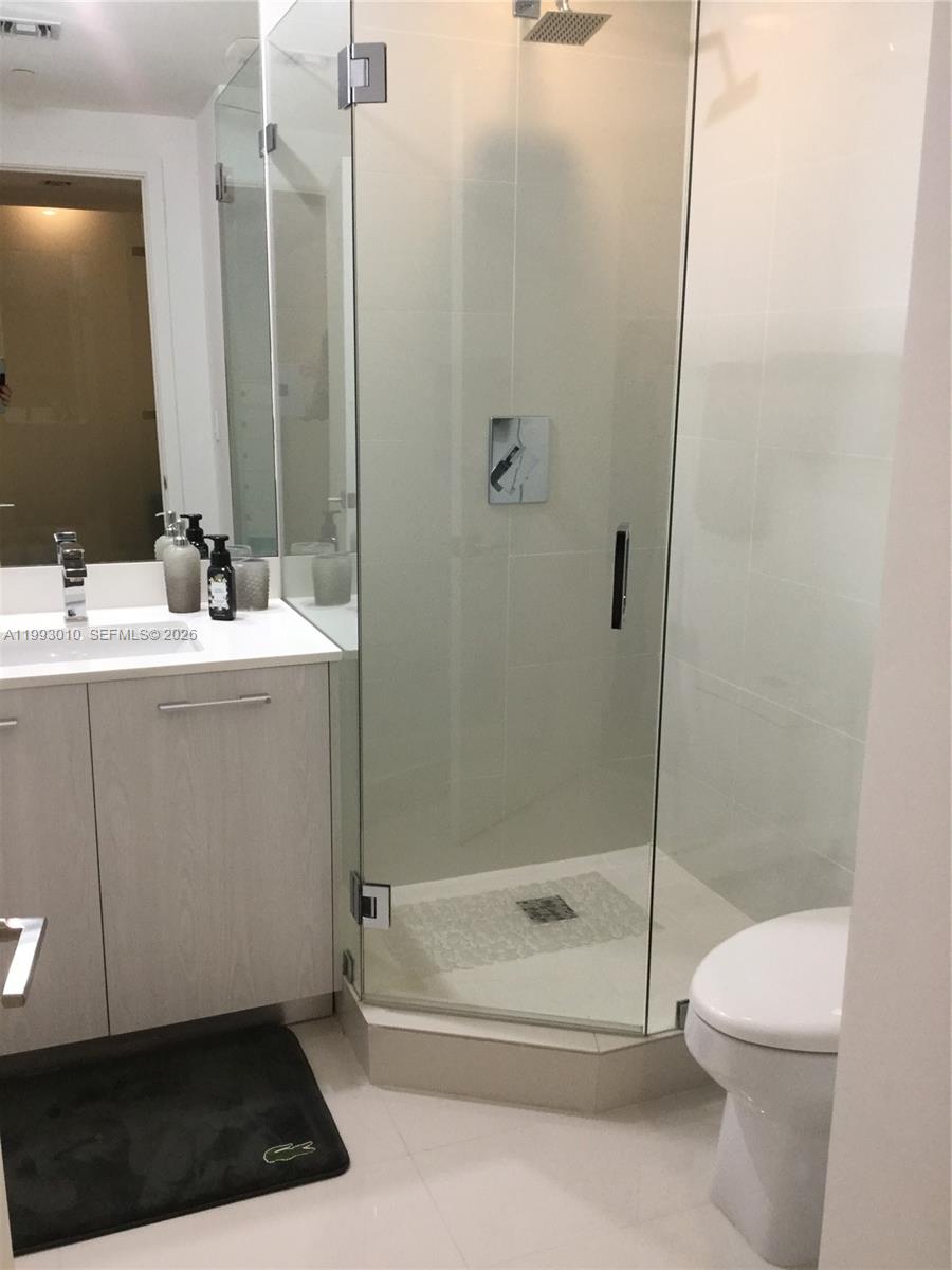 55 Southwest 9th Street, Unit 1905 Miami, FL 33130 - Photo 14 of 19 a bathroom with a sink a toilet and shower