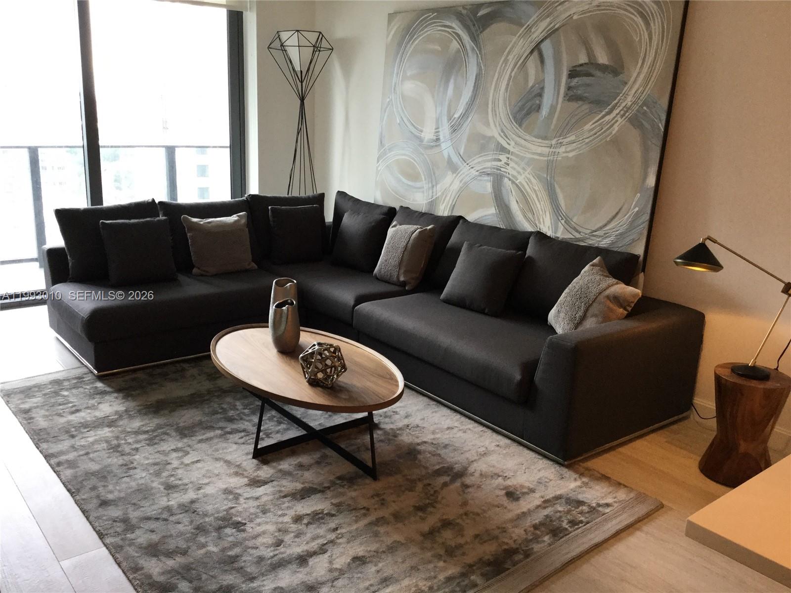 55 Southwest 9th Street, Unit 1905 Miami, FL 33130 - Photo 6 of 19 a living room with furniture and a rug
