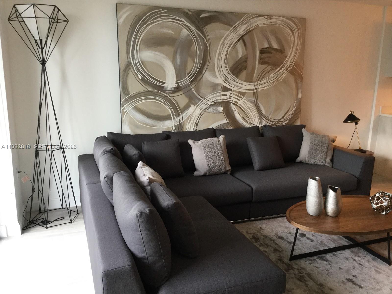 55 Southwest 9th Street, Unit 1905 Miami, FL 33130 - Photo 8 of 19 a living room with furniture and a rug