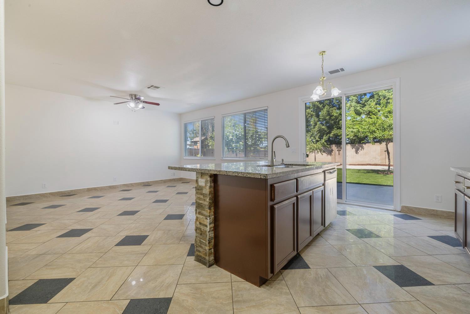 3105 Ripple Court Modesto, CA 95355 - Photo 11 of 46 a kitchen with a sink a counter top space and appliances