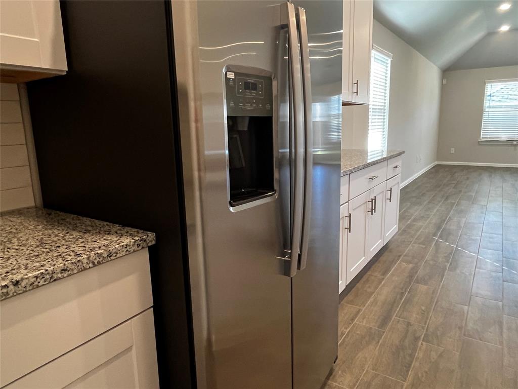 409 Wydown Drive Princeton, TX 75407 - Photo 16 of 29 a kitchen with granite countertop a refrigerator and a sink