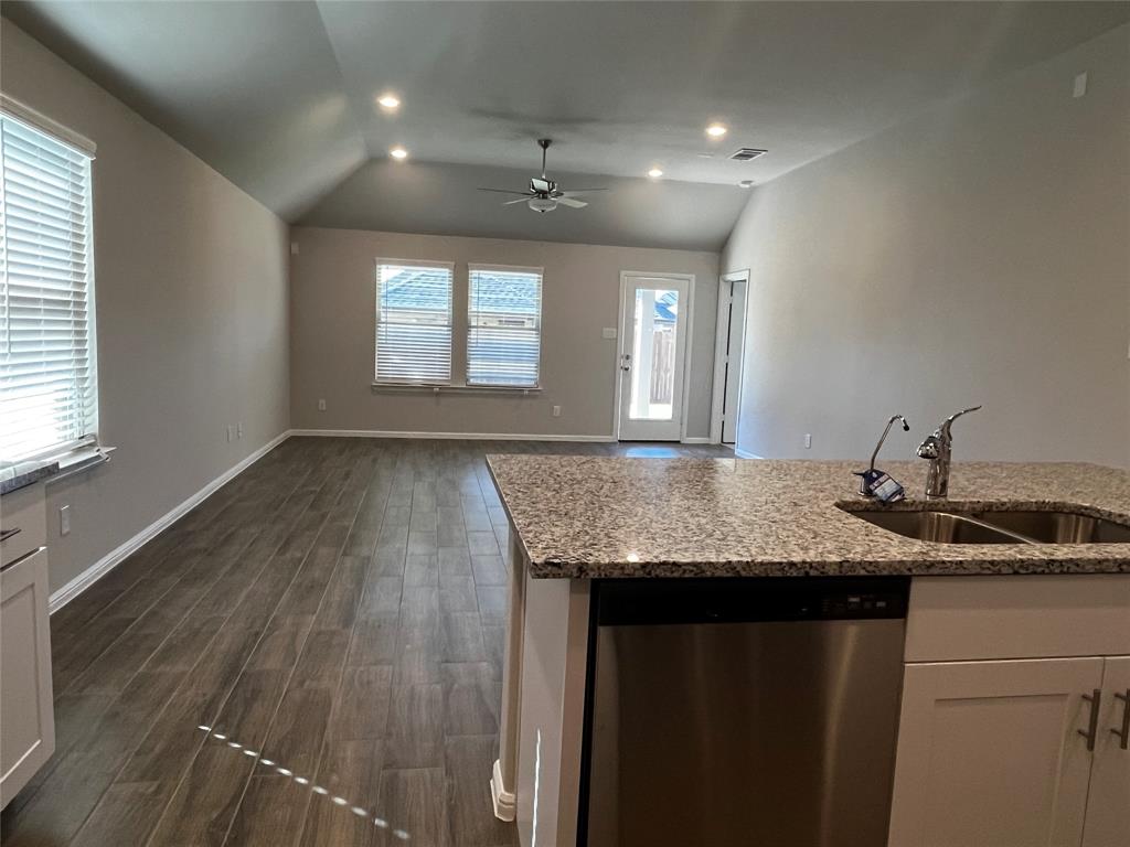 409 Wydown Drive Princeton, TX 75407 - Photo 17 of 29 a bathroom with a granite countertop sink a window and a mirror