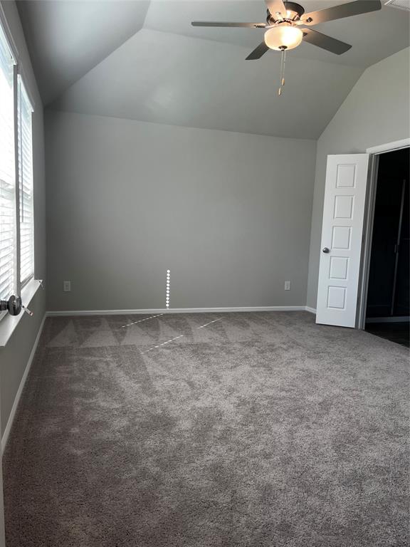 409 Wydown Drive Princeton, TX 75407 - Photo 22 of 29 an empty room with a chandelier fan and windows