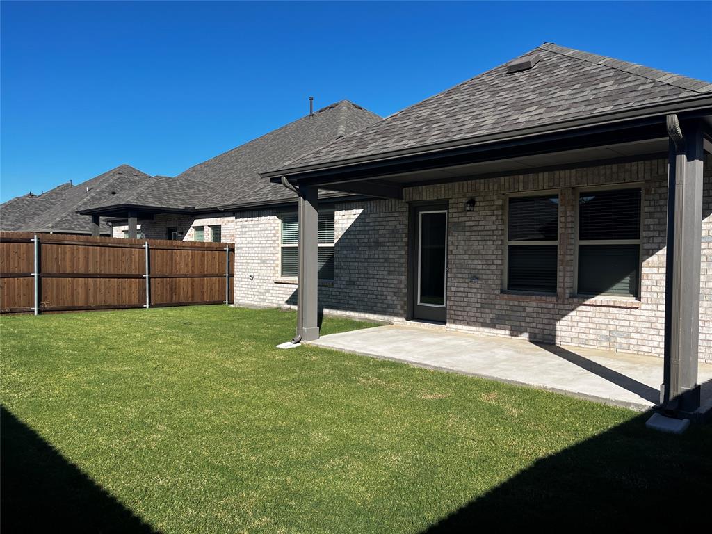 409 Wydown Drive Princeton, TX 75407 - Photo 28 of 29 a view of a backyard with a tub and wooden fence