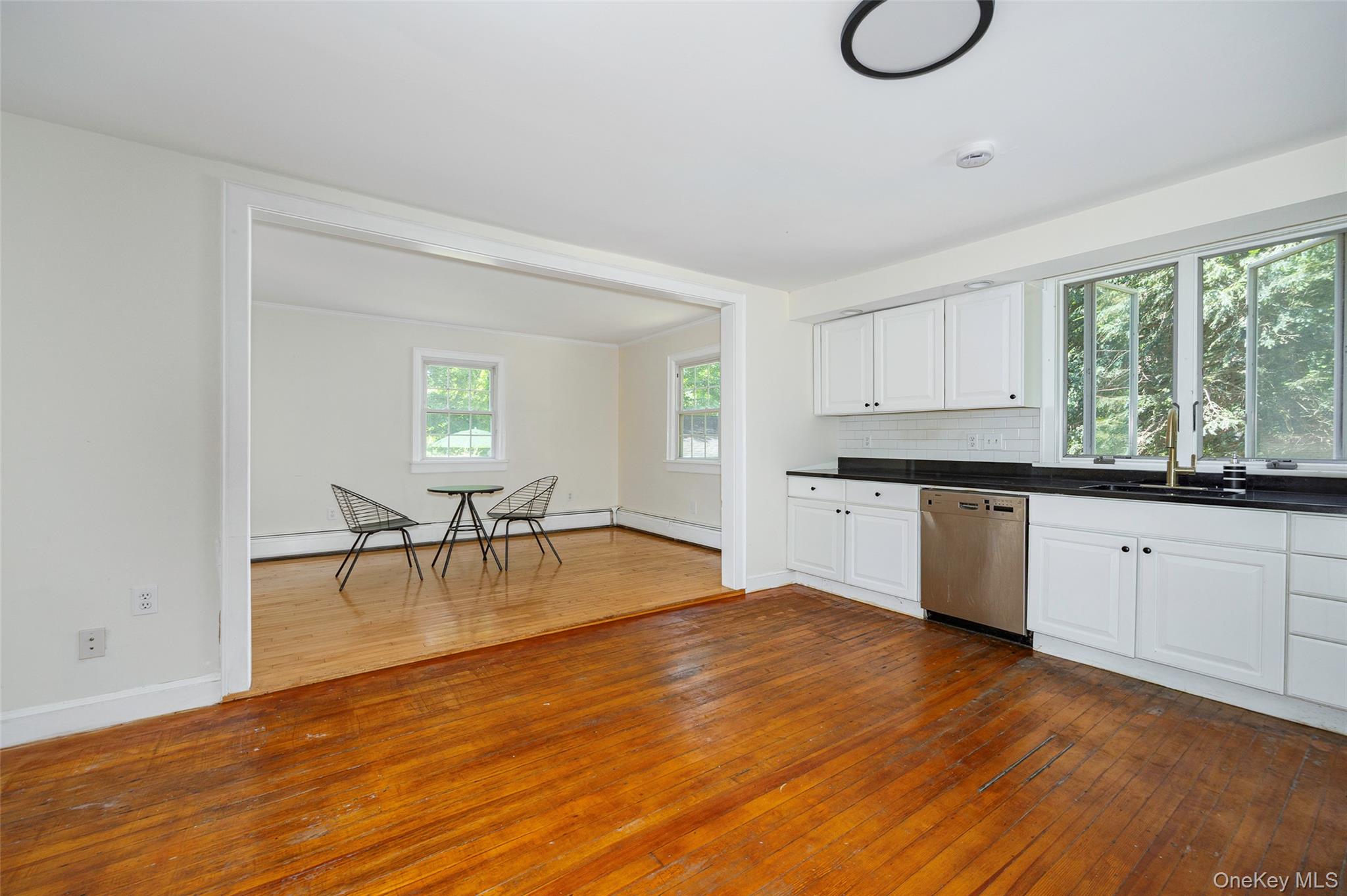 83-85 Old Post Road Staatsburg, NY 12580 - Photo 11 of 36 a kitchen with granite countertop a stove a oven a dining table and chairs with wooden floor