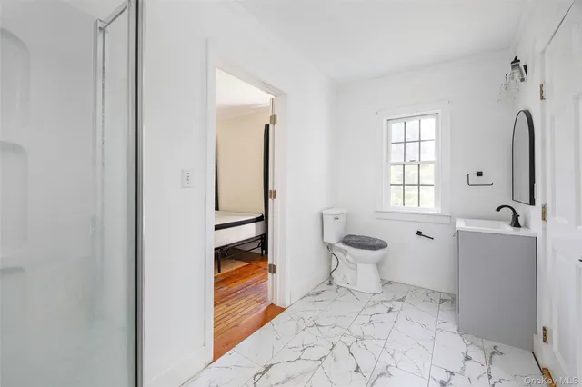 a bathroom with a sink toilet and shower