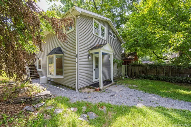 a view of a small house with a yard