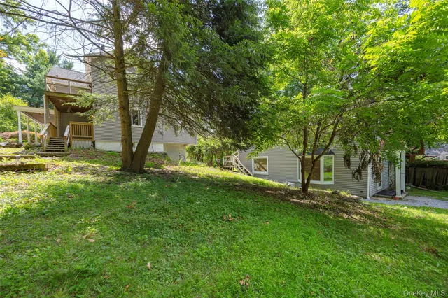 a view of a backyard with large trees
