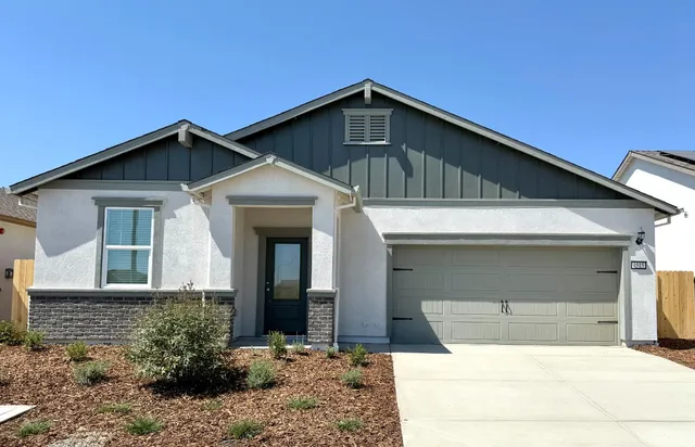 a front view of a house with garage