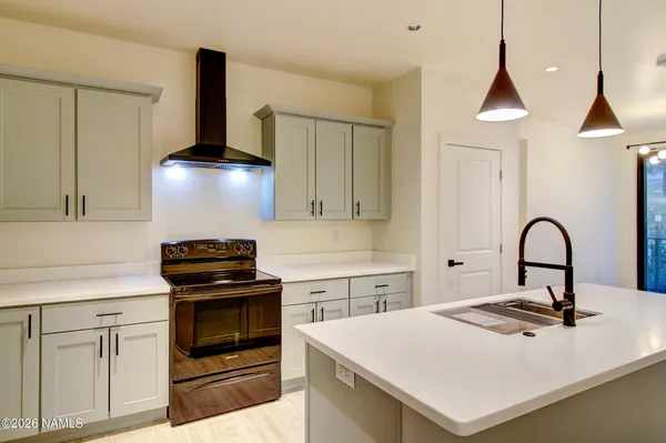 a kitchen with a stove a sink and a refrigerator
