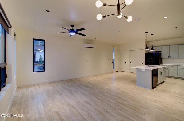 a view of a kitchen with a microwave and wooden floor