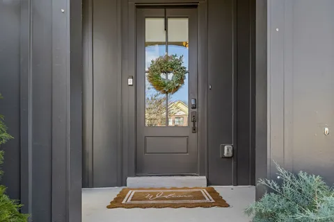 a view of a hallway with wooden floor and entryway