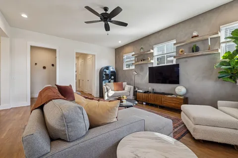 a living room with furniture potted plant and a window