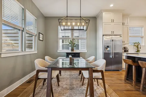 a kitchen with kitchen island granite countertop a sink a center island and stainless steel appliances