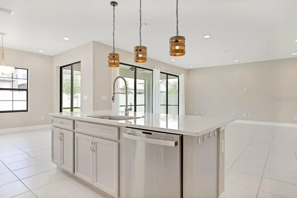 a kitchen with stainless steel appliances granite countertop a stove a refrigerator and a sink