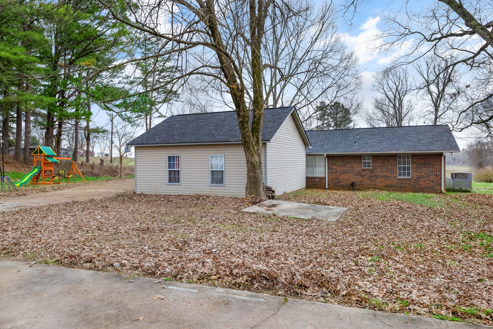9472 Highway 59 Burlison, TN 38015 - Photo 5 of 34 a front view of a house with a yard and garage