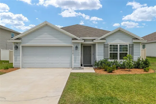a front view of house with yard and green space