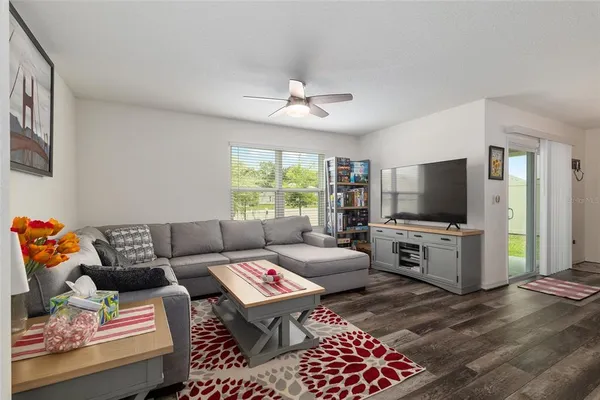 a kitchen with stainless steel appliances granite countertop a stove top oven a sink a refrigerator and white cabinets