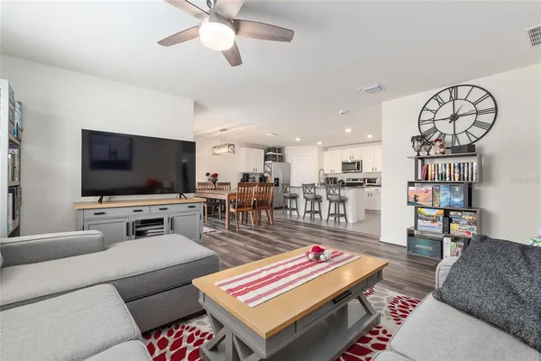 a kitchen with stainless steel appliances granite countertop a kitchen island a stove a table and chairs