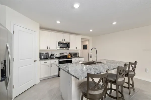 a kitchen that has a table and chairs in it