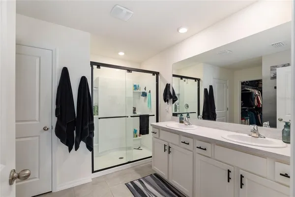 a bedroom with a bed furniture and a large window