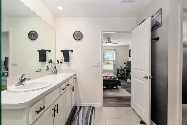 a living room with furniture a rug and a bookshelf