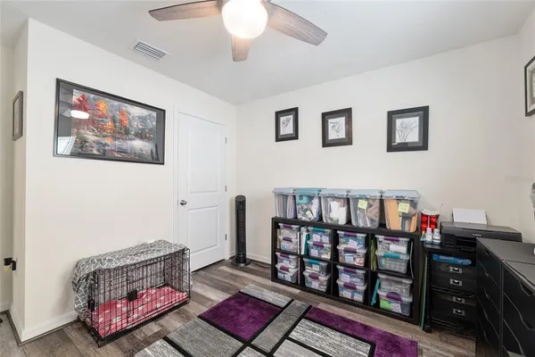 a view of a house next to a yard with big trees
