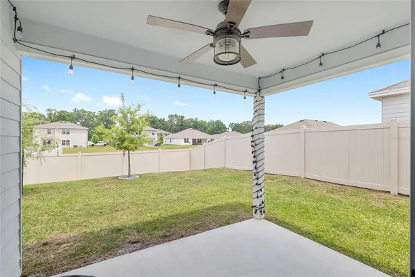 a aerial view of a house with swimming pool and a yard