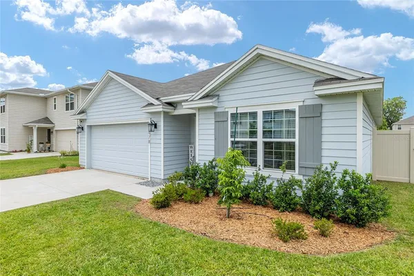 a hallway with beautiful frames and flower vase