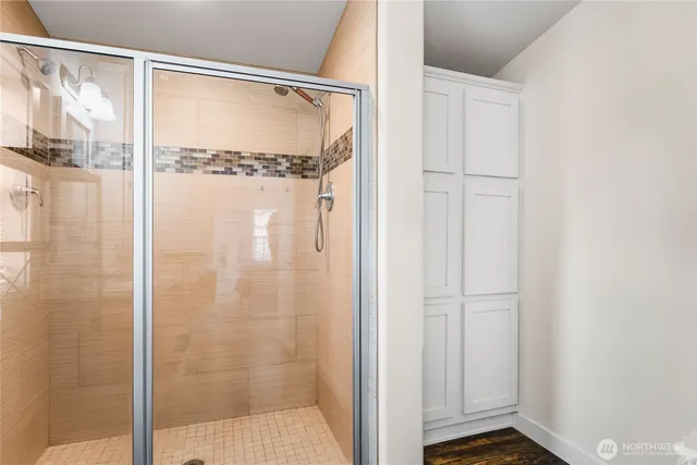 a bathroom with a glass shower door