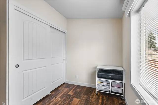 a view of room with window and wooden floor