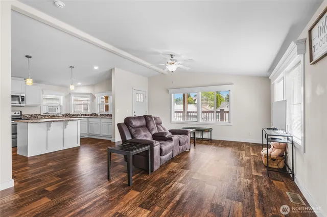 a living room with furniture and a wooden floor