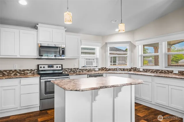 a kitchen with sink stove and cabinets