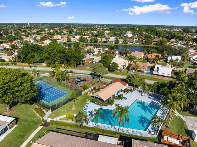 an aerial view of residential houses with outdoor space and river
