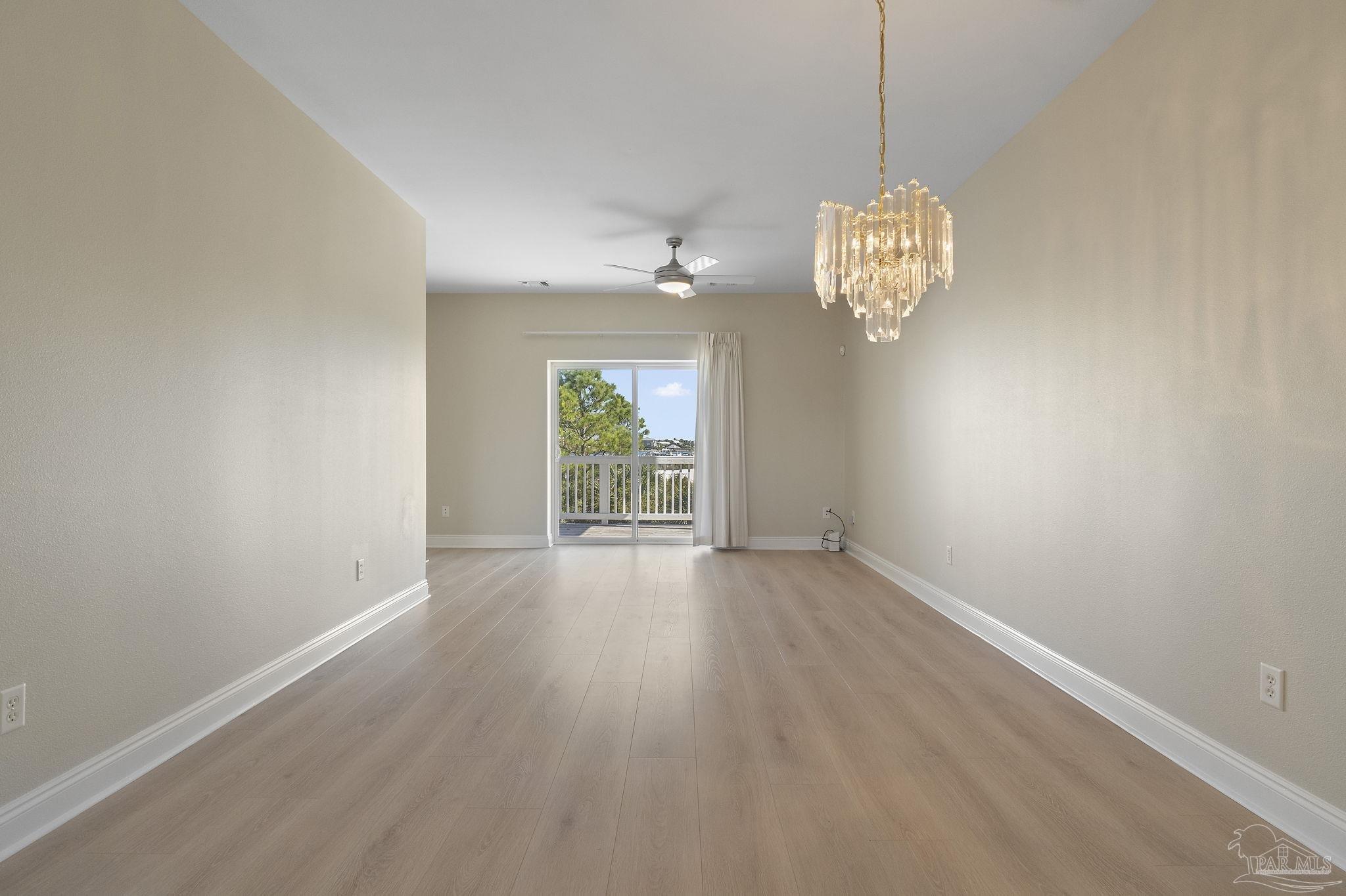 16300 Perdido Key Drive, Unit 20 Perdido Key, FL 32507 - Photo 12 of 47 an empty room with wooden floor and windows