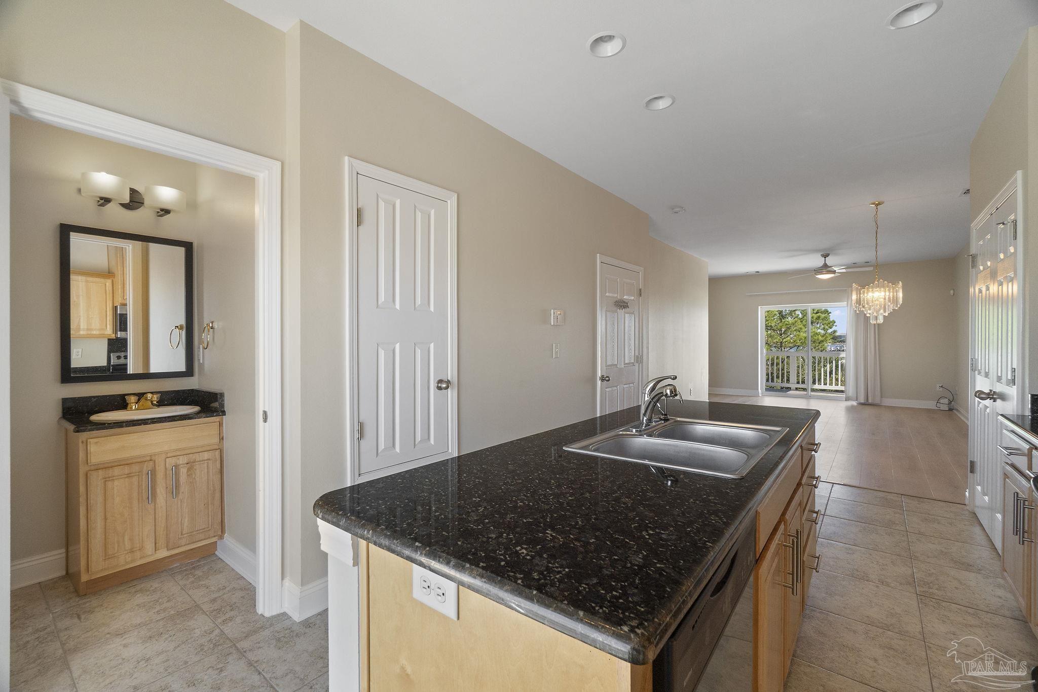 16300 Perdido Key Drive, Unit 20 Perdido Key, FL 32507 - Photo 19 of 47 a kitchen with granite countertop a sink a stove and a refrigerator