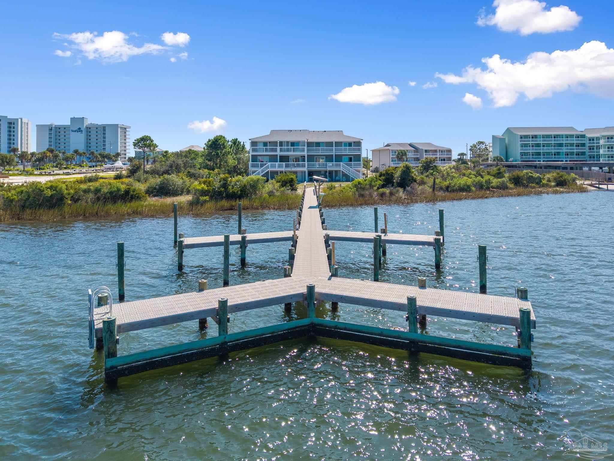 16300 Perdido Key Drive, Unit 20 Perdido Key, FL 32507 - Photo 2 of 47 a view of a bench in the middle of a lake