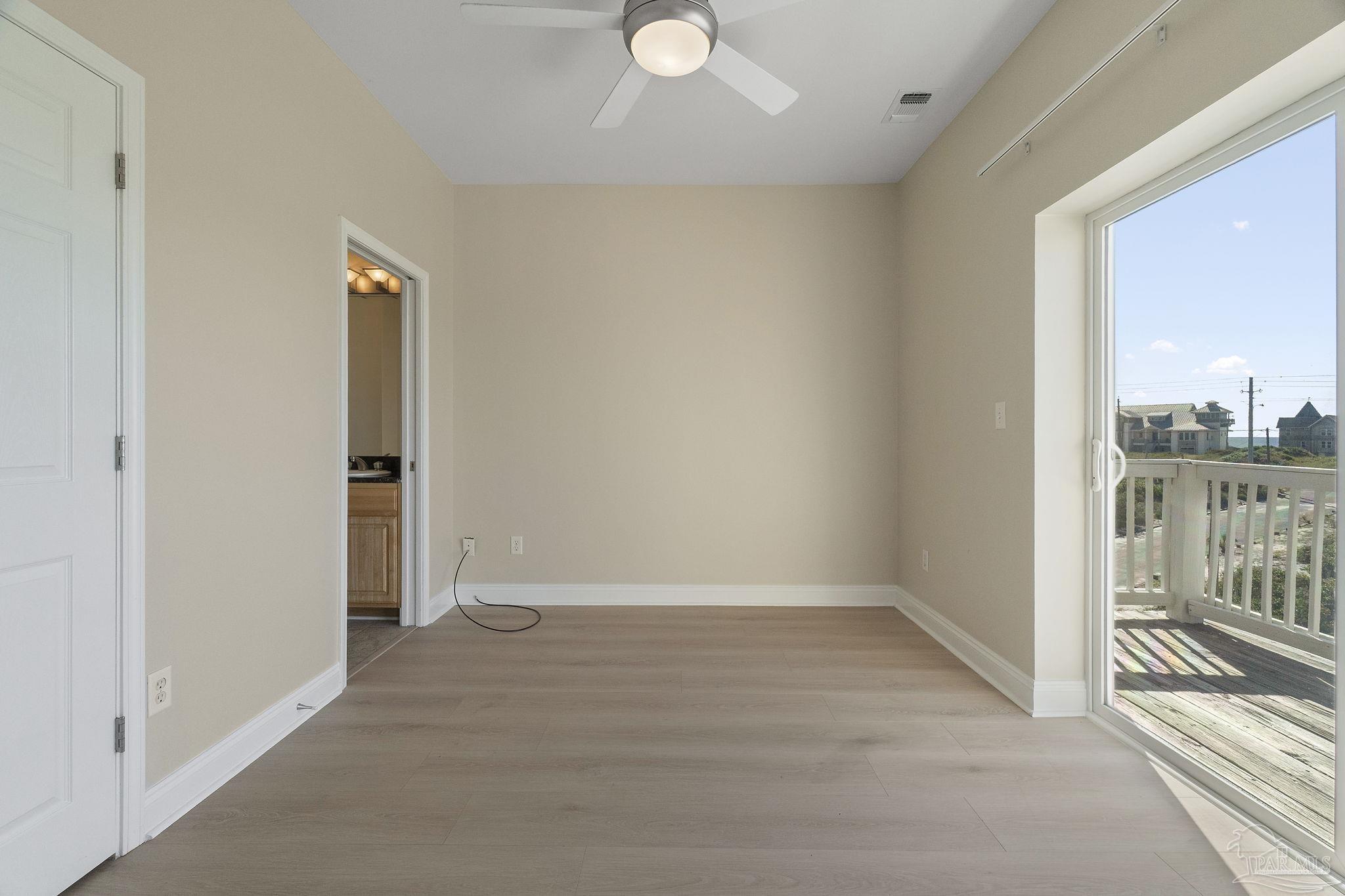 16300 Perdido Key Drive, Unit 20 Perdido Key, FL 32507 - Photo 24 of 47 an empty room with wooden floor and windows