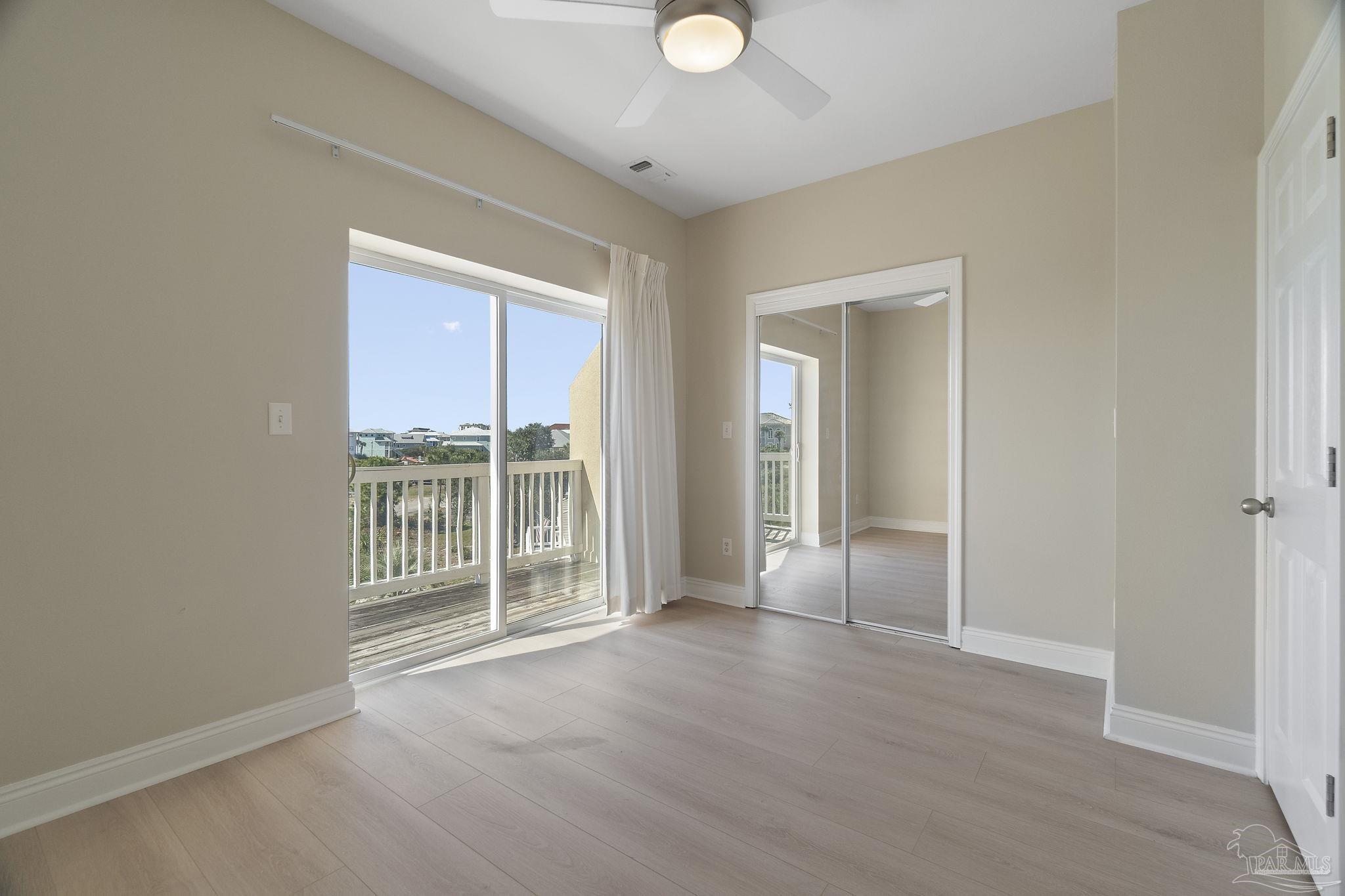16300 Perdido Key Drive, Unit 20 Perdido Key, FL 32507 - Photo 25 of 47 an empty room with wooden floor and windows