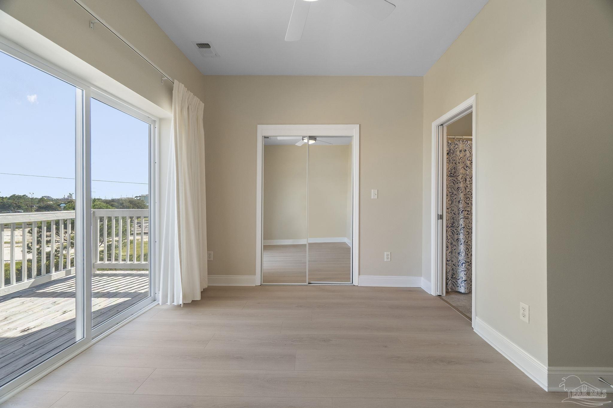 16300 Perdido Key Drive, Unit 20 Perdido Key, FL 32507 - Photo 28 of 47 an empty room with windows and closet