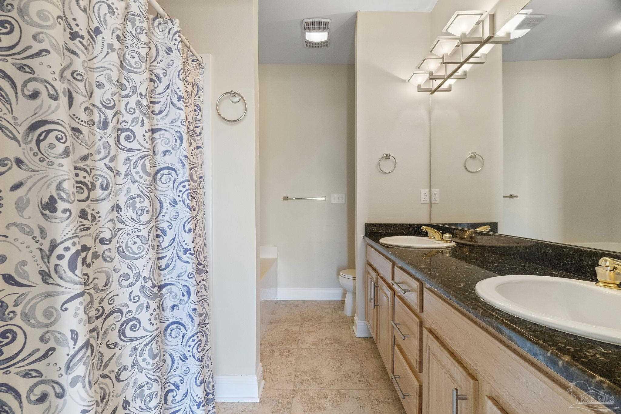 16300 Perdido Key Drive, Unit 20 Perdido Key, FL 32507 - Photo 31 of 47 a bathroom with a granite countertop sink and a mirror