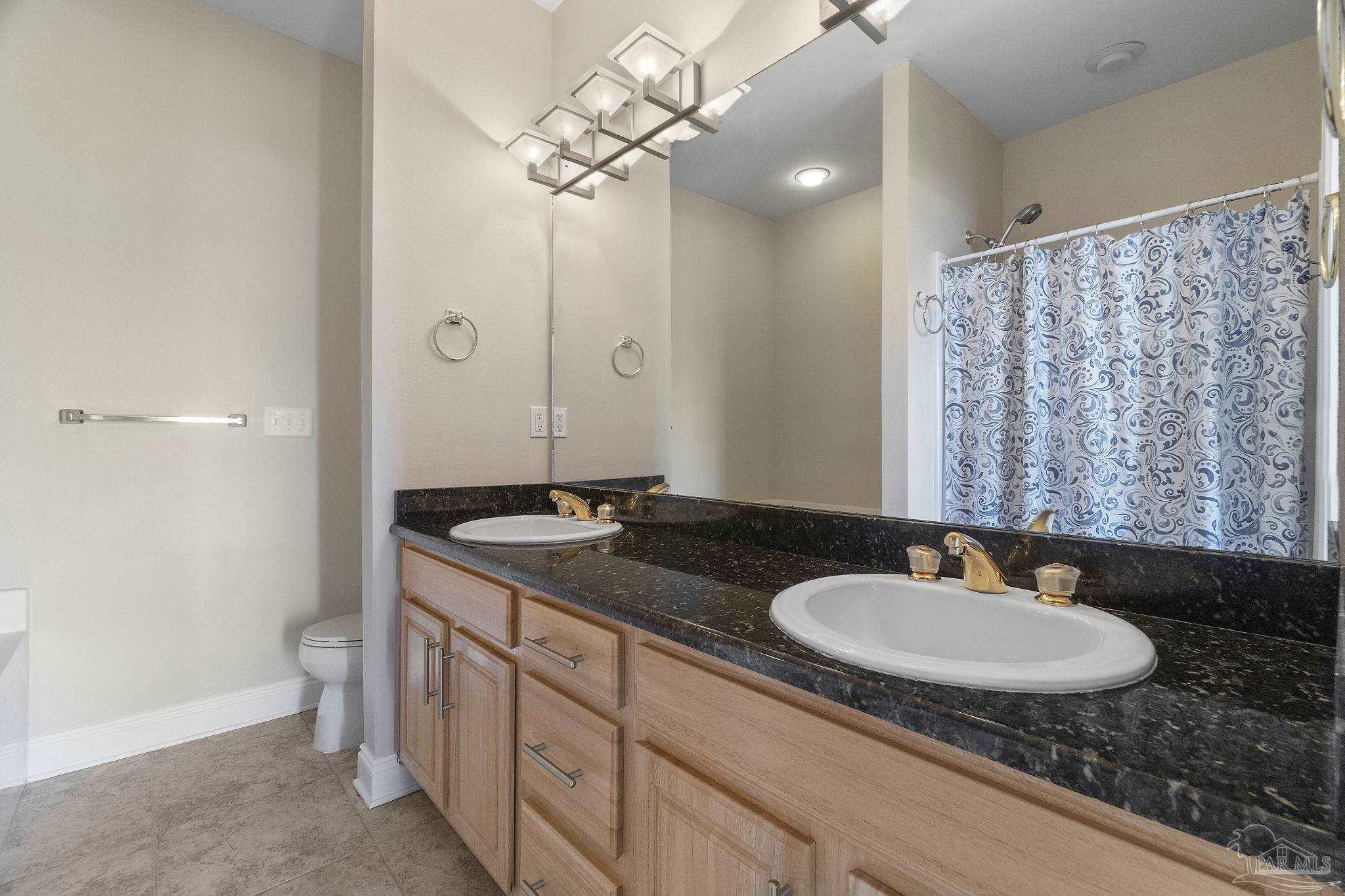 16300 Perdido Key Drive, Unit 20 Perdido Key, FL 32507 - Photo 32 of 47 a bathroom with a granite countertop sink a mirror a vanity and a shower