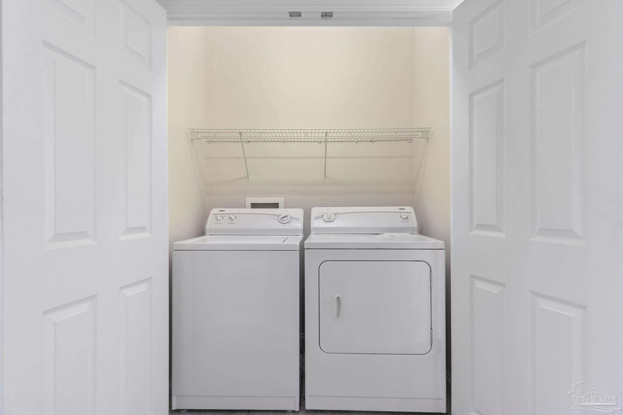 16300 Perdido Key Drive, Unit 20 Perdido Key, FL 32507 - Photo 35 of 47 a utility room with dryer and washer