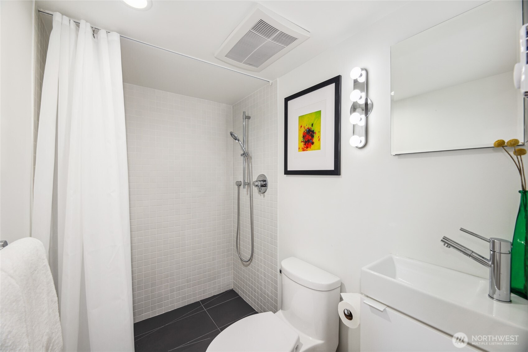 115 East Allison Street Seattle, WA 98102 - Photo 17 of 23 a white toilet sitting next to a bathroom sink and a shower