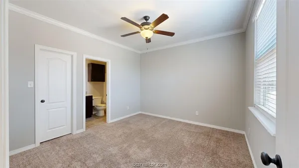an empty room with closet and windows